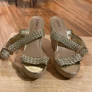 This shoe is a size 10 wedges, gold strap up in front